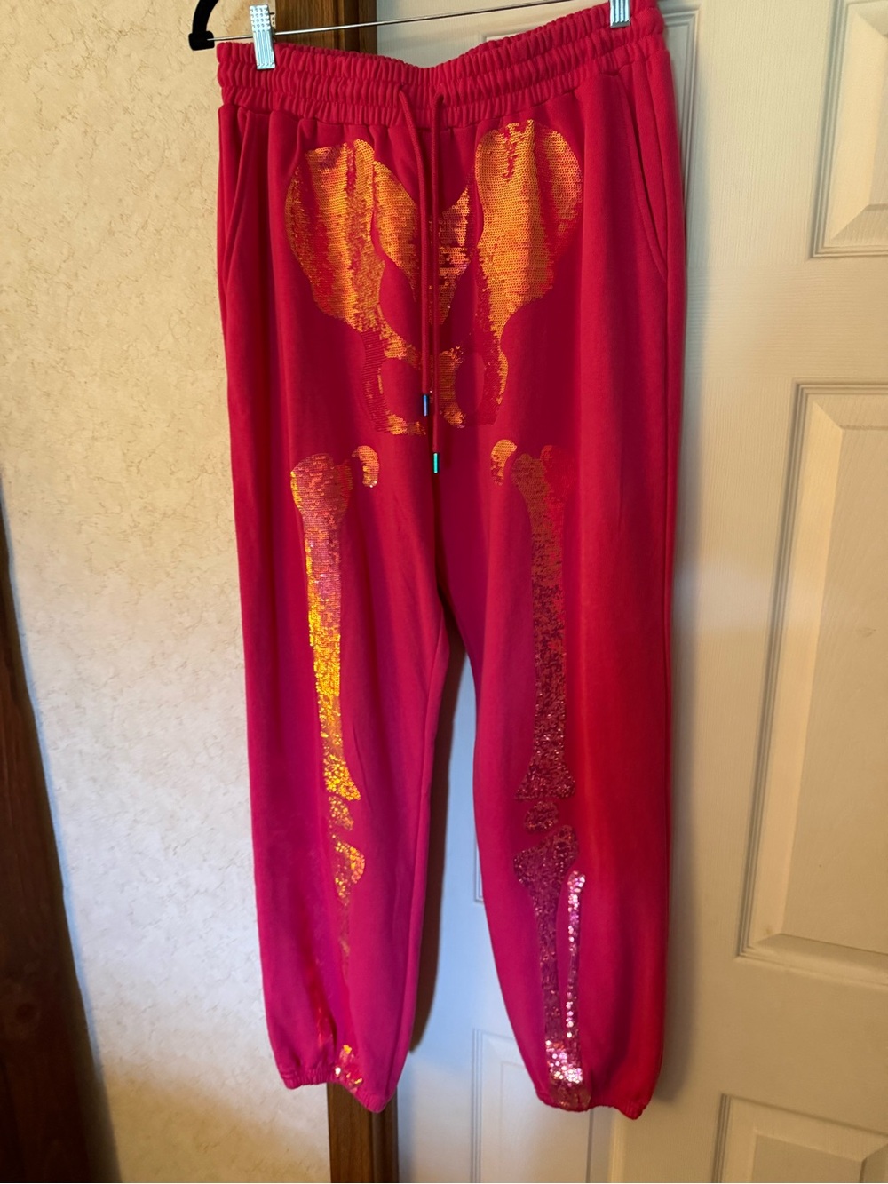 QUEEN OF SPARKLES Hot Pink Joggers with Gold Sequin Skeleton Detail